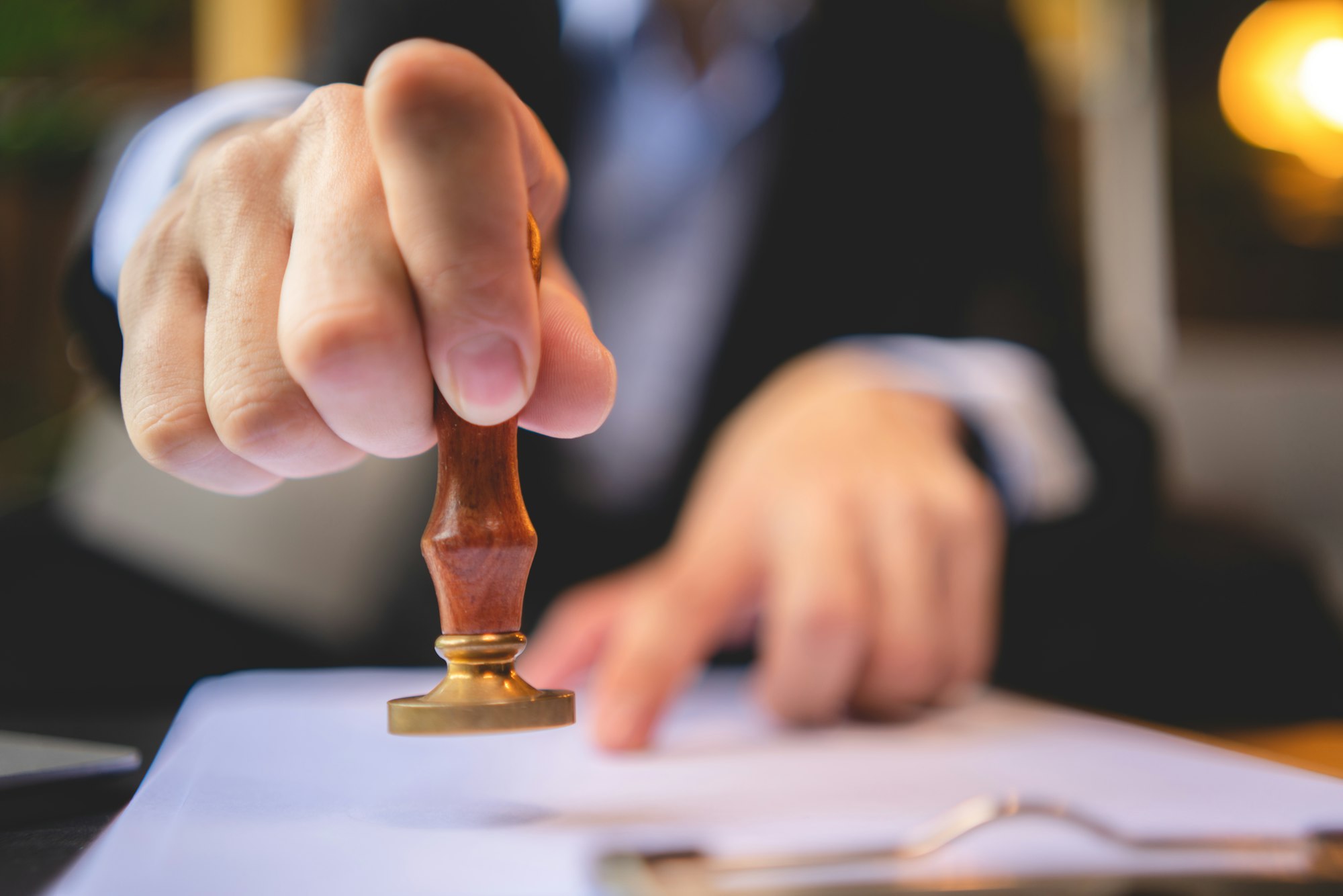 hand stamping with approved stamp on approval certificate document public paper at desk